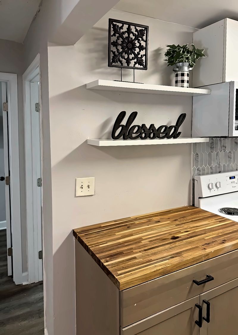 Kitchen shelves above a butcher-block counter, next to the stove