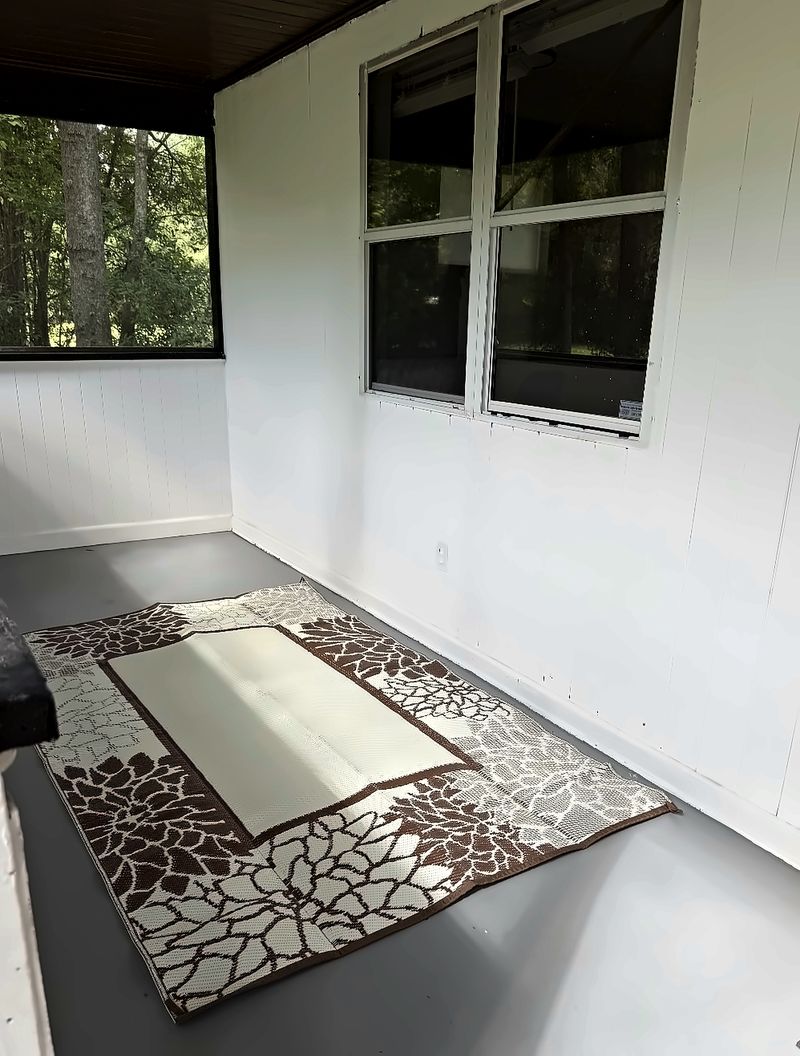Screened porch with an outdoor rug