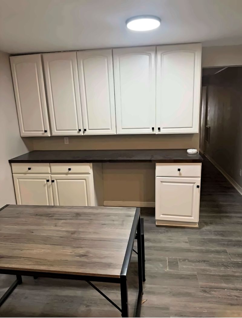 Extra cabinets and counter space, next to a table