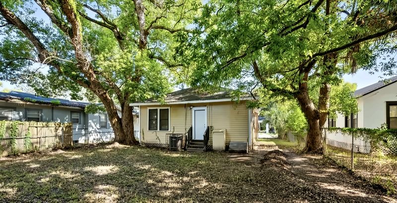 Backyard shaded by large oak trees